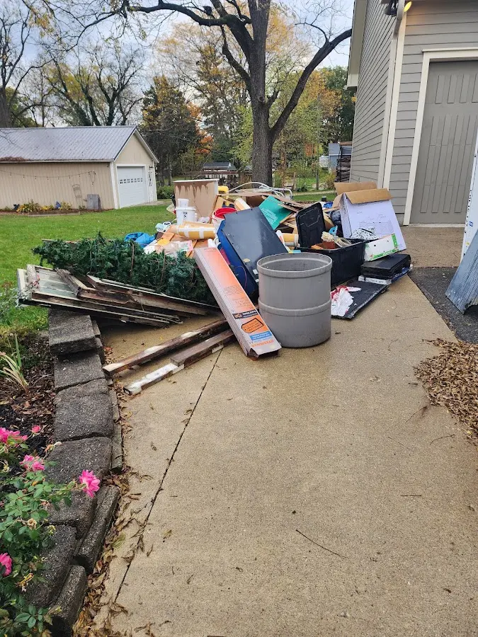 Dumpster being loaded with debris for Roofing Dumpster Rental in Griswold